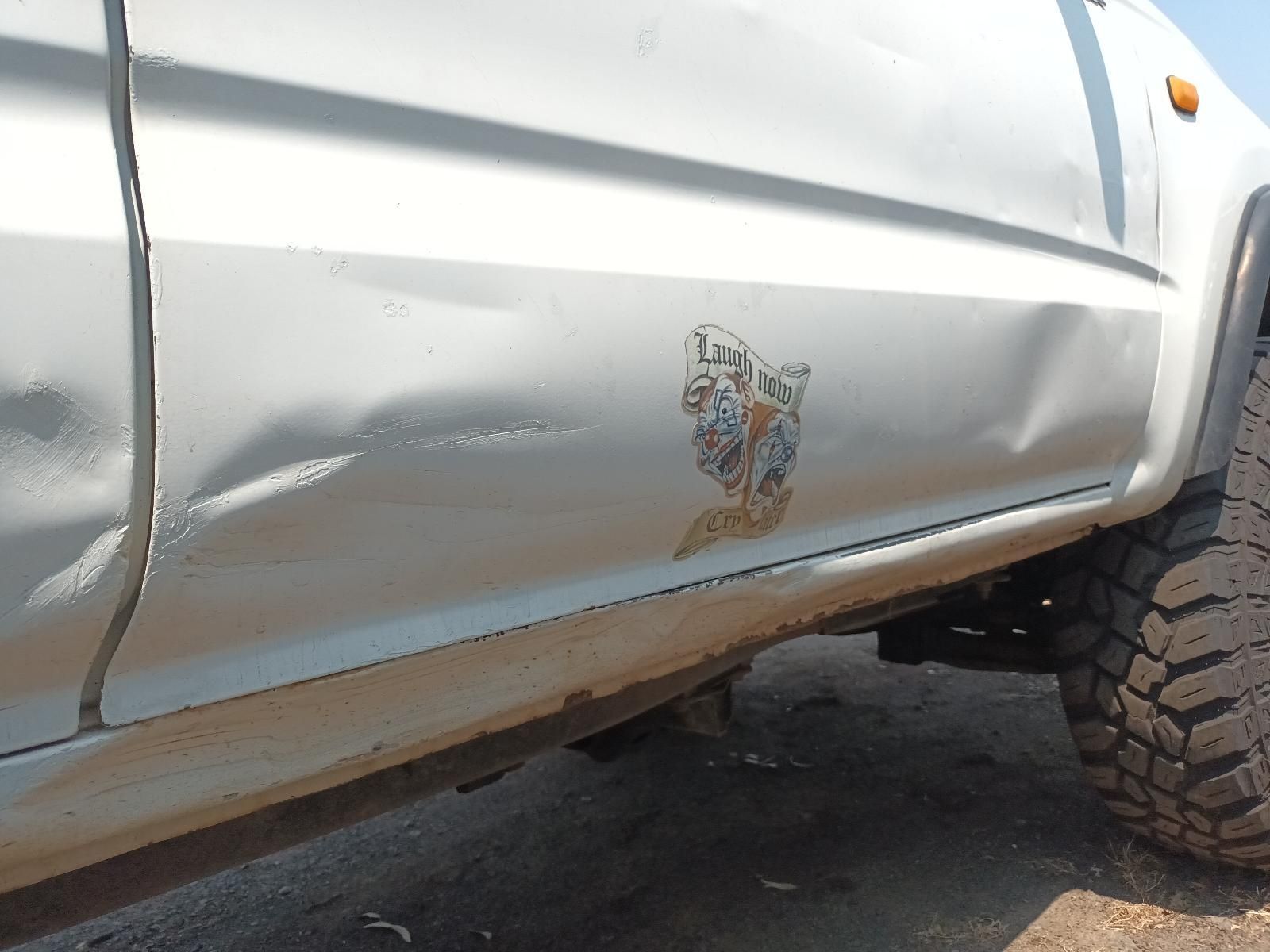 Dent on White Truck Door with Rust Along the Rocker Panel — South West 4WD Wreckers In Harristown, QLD