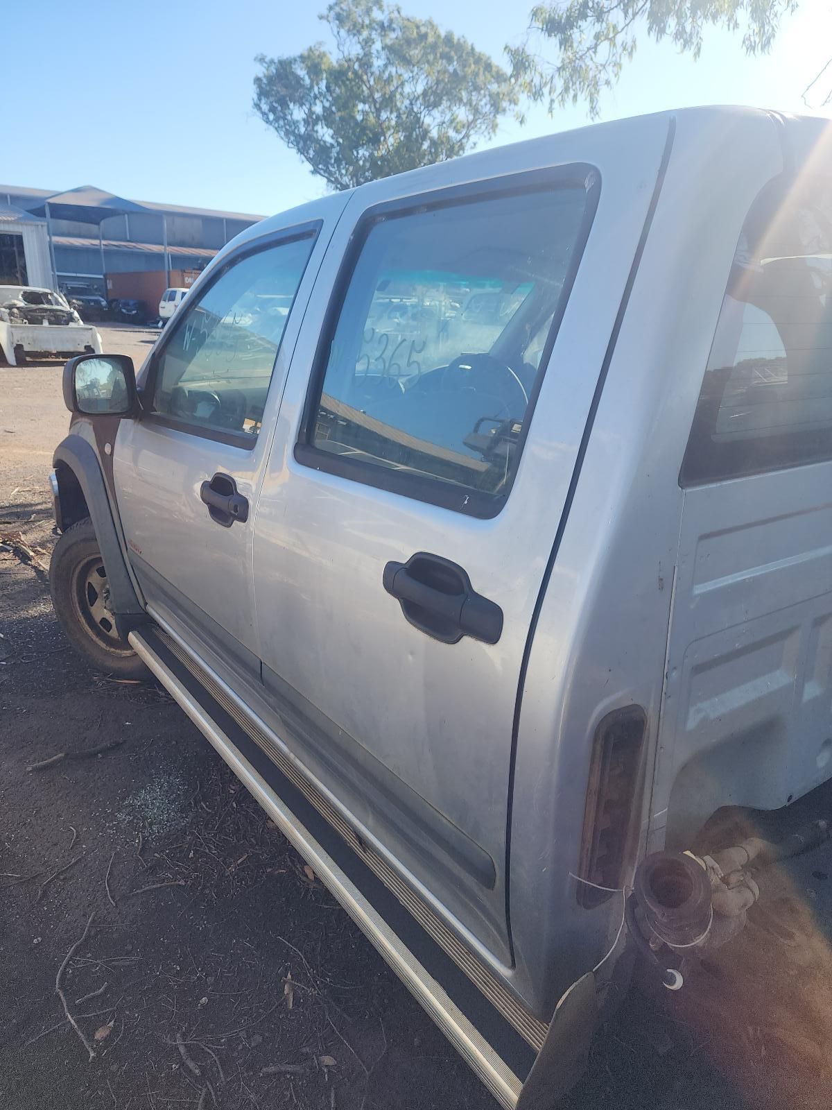 Silver Pickup Truck Parked in A Lot, Side View with Tinted Windows — South West 4WD Wreckers In Harristown, QLD