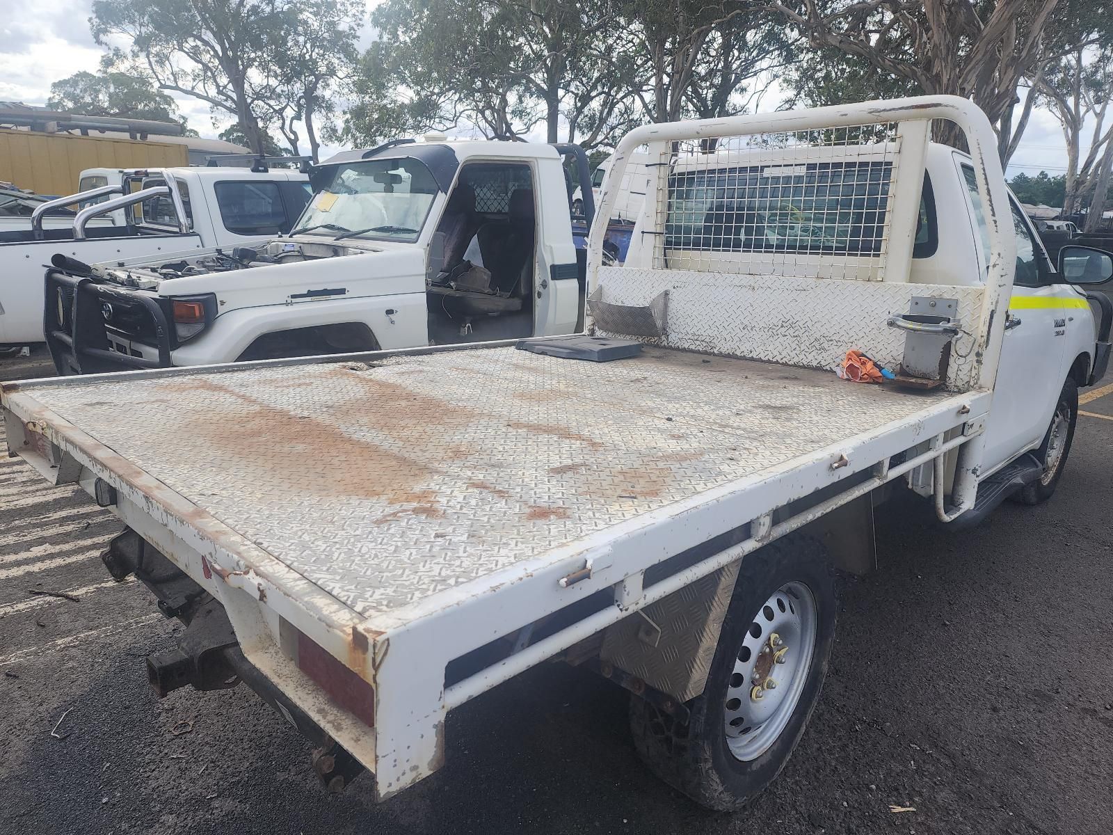 White Flatbed Truck Parked Outdoors, Covered in Mud — South West 4WD Wreckers In Harristown, QLD