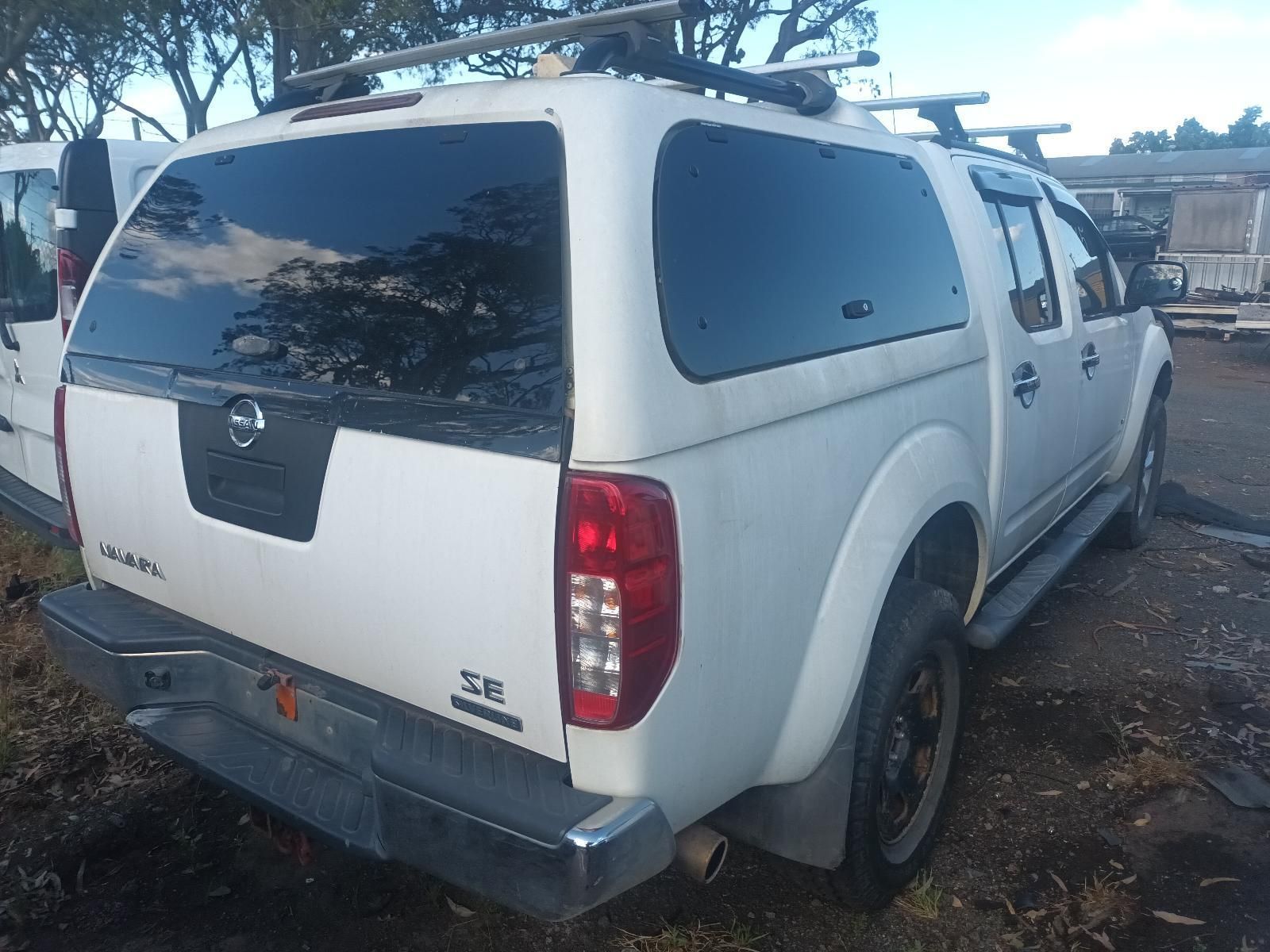 White Nissan Pickup Truck Parked Outdoors — South West 4WD Wreckers In Harristown, QLD