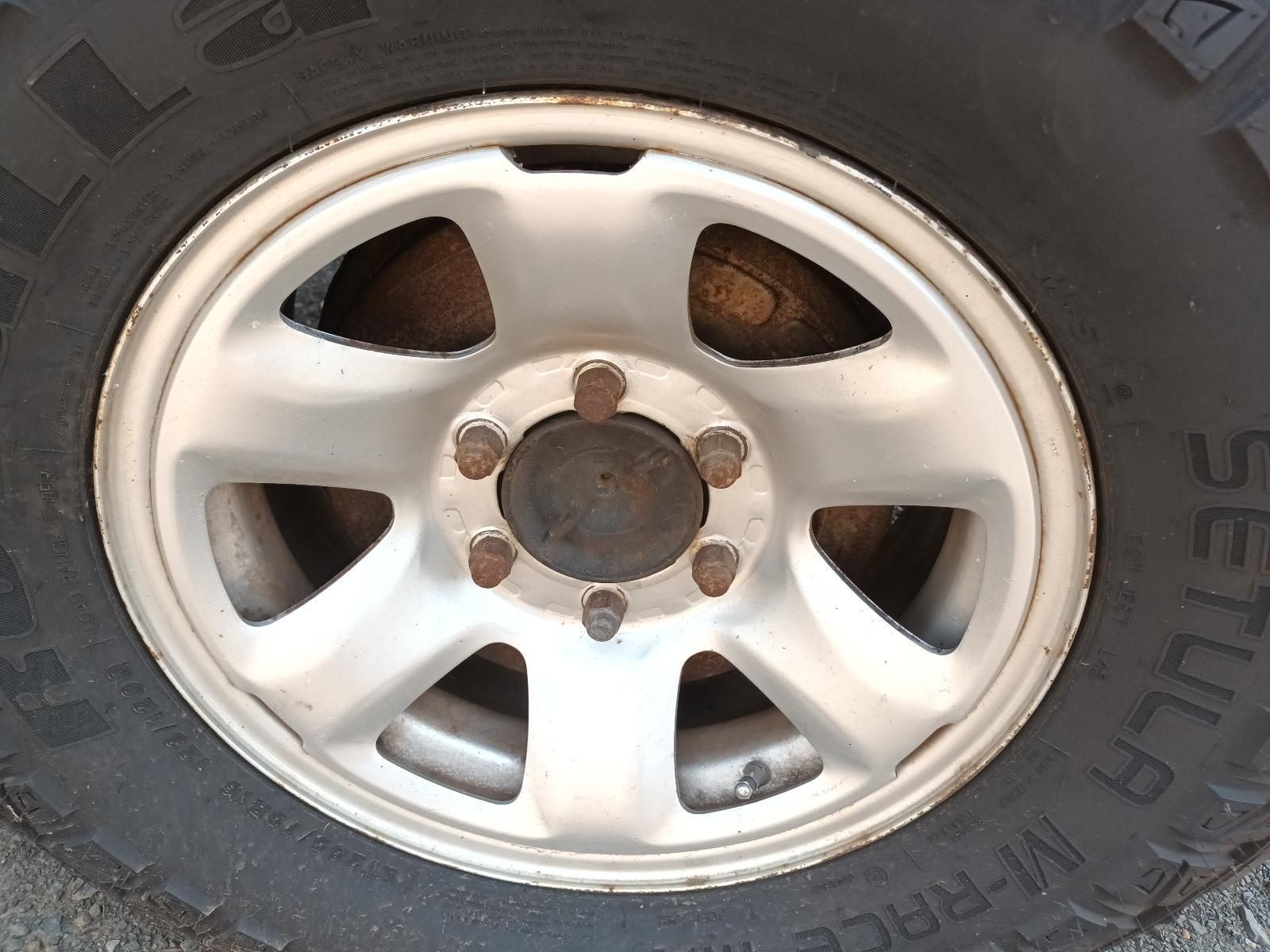 Close-Up of A Silver Car Wheel Rim with Five Lug Nuts — South West 4WD Wreckers In Harristown, QLD