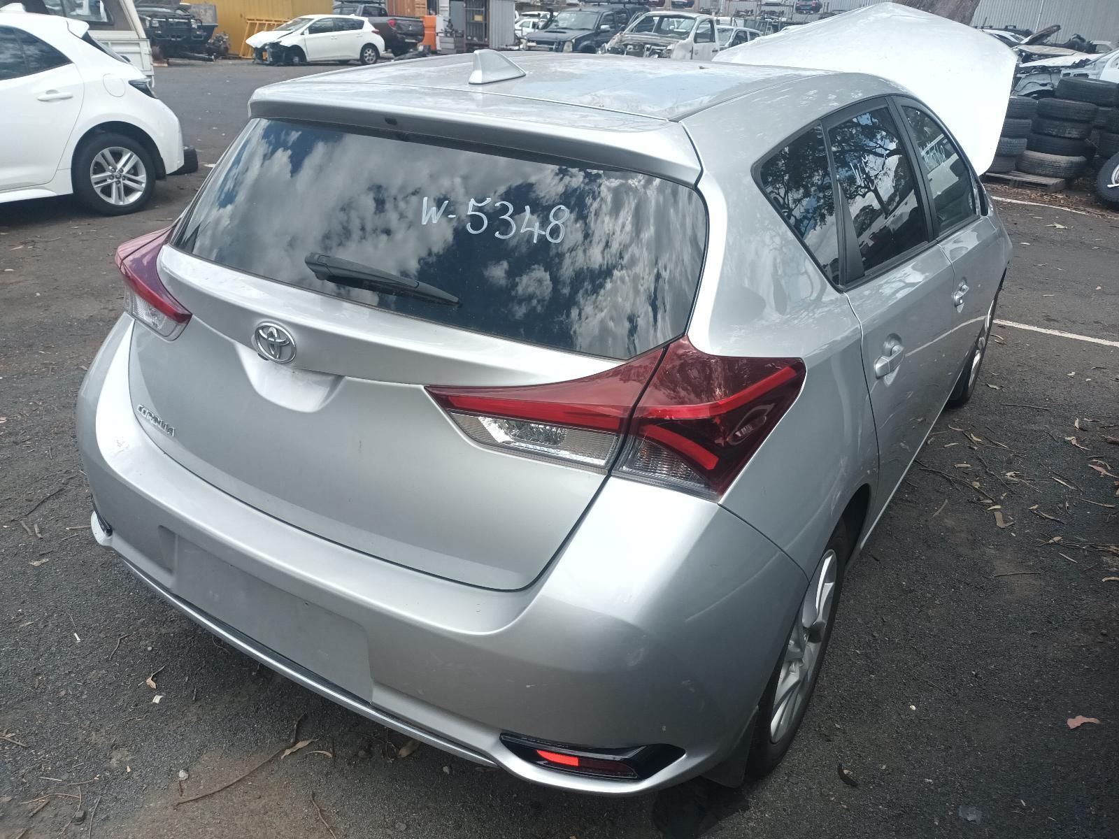 Silver Hatchback Parked on A Wet Lot, Rear View with Frosted Windows — South West 4WD Wreckers In Harristown, QLD