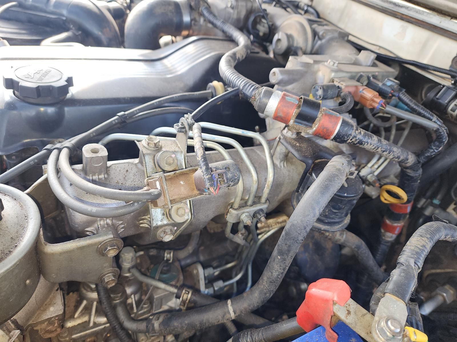 Dirty Car Engine Bay With Hoses, Wiring — South West 4WD Wreckers In Harristown, QLD