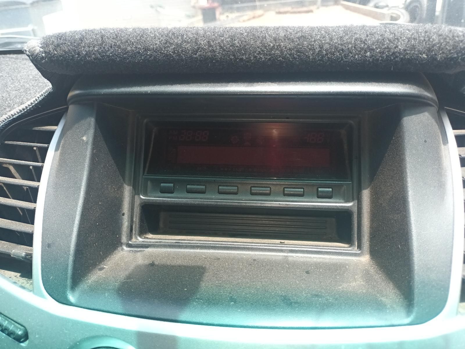 Car Dashboard Center Console with A Dusty Red Display and Stereo Controls — South West 4WD Wreckers In Harristown, QLD