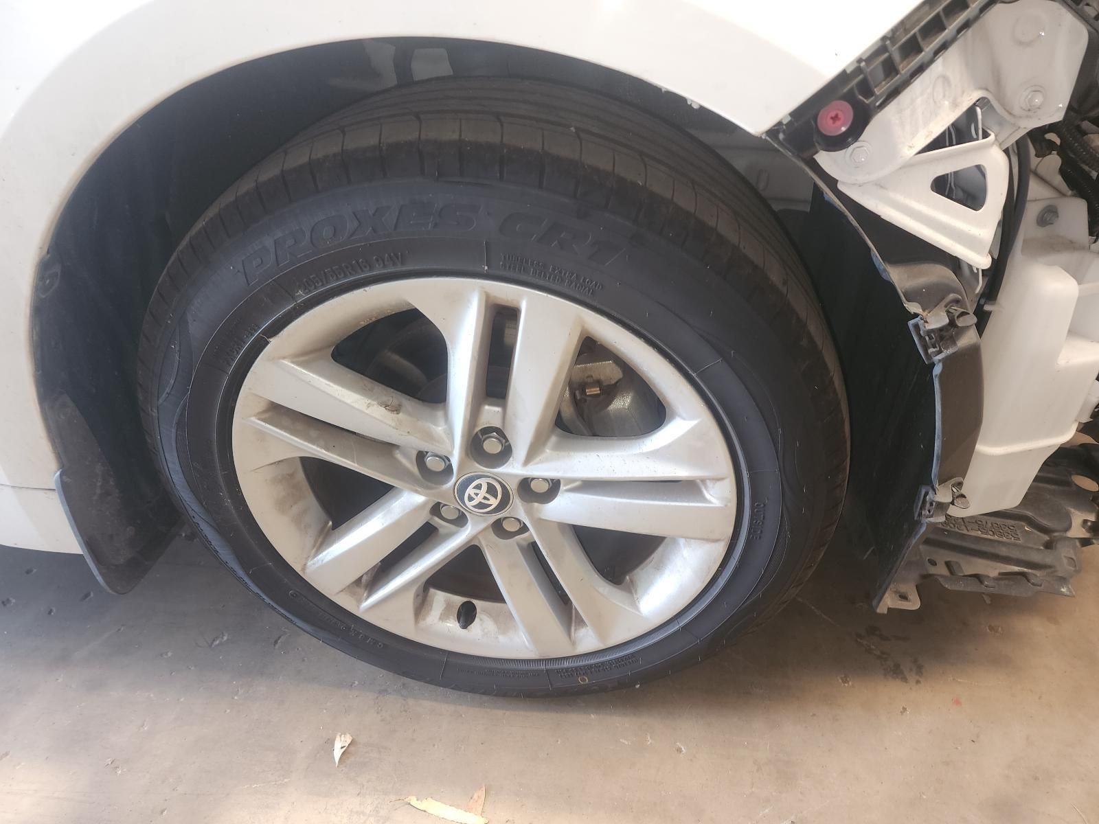 Damaged White Car Front Wheel — South West 4WD Wreckers In Harristown, QLD
