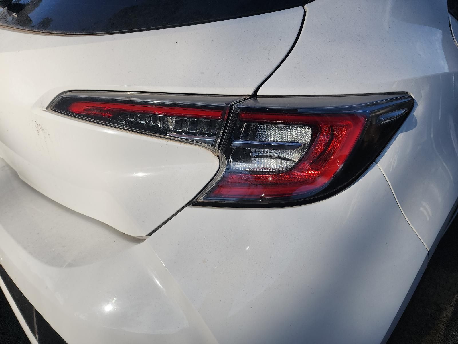 Close-up of a White Car’s Rear Taillight — South West 4WD Wreckers In Harristown, QLD