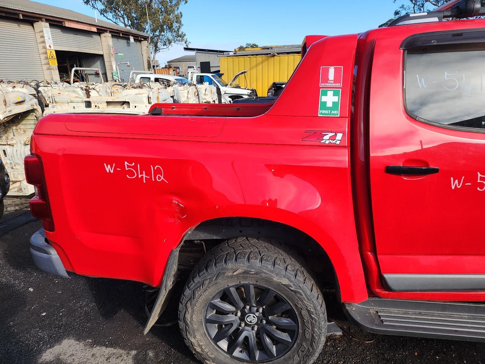 Red Pickup Truck Parked Outdoors With a Crushed Bed — South West 4WD Wreckers In Harristown, QLD