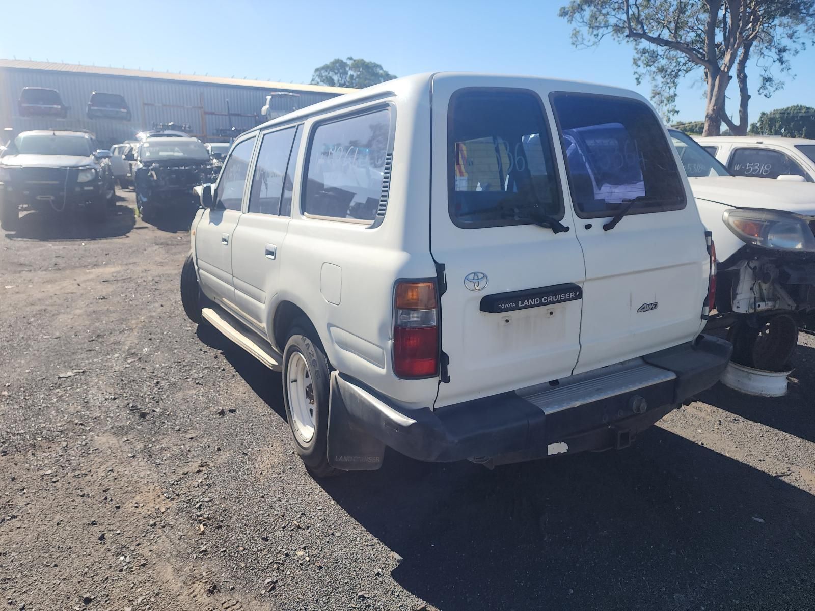 White Van Parked in A Lot, Rear View with A Damaged Bumper and Windows — South West 4WD Wreckers In Harristown, QLD