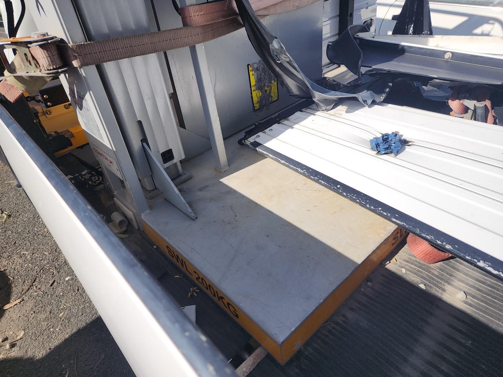 Folded Mobility Aid on a Ramp Beside a Vehicle — South West 4WD Wreckers In Harristown, QLD