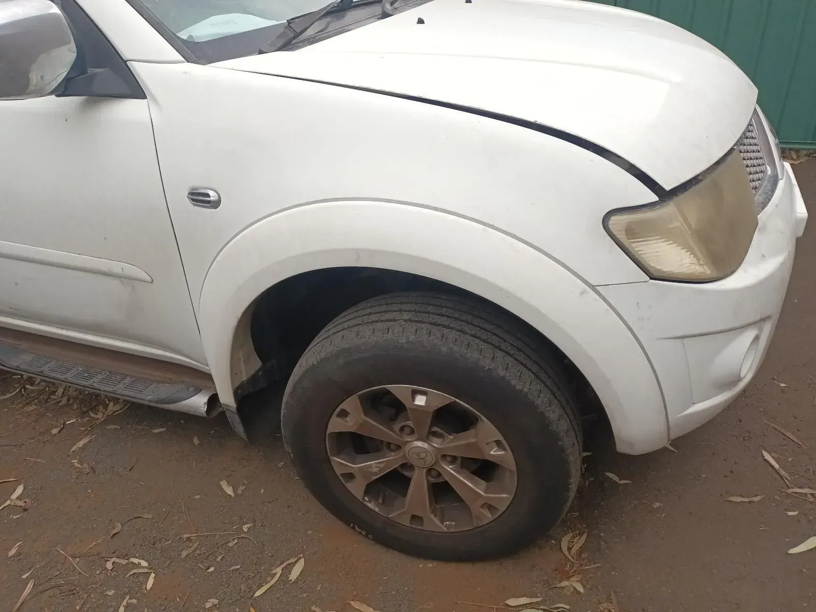 White Mitsubishi Triton Truck, Front-side View, With a Dirty Tyre — South West 4WD Wreckers In Harristown, QLD