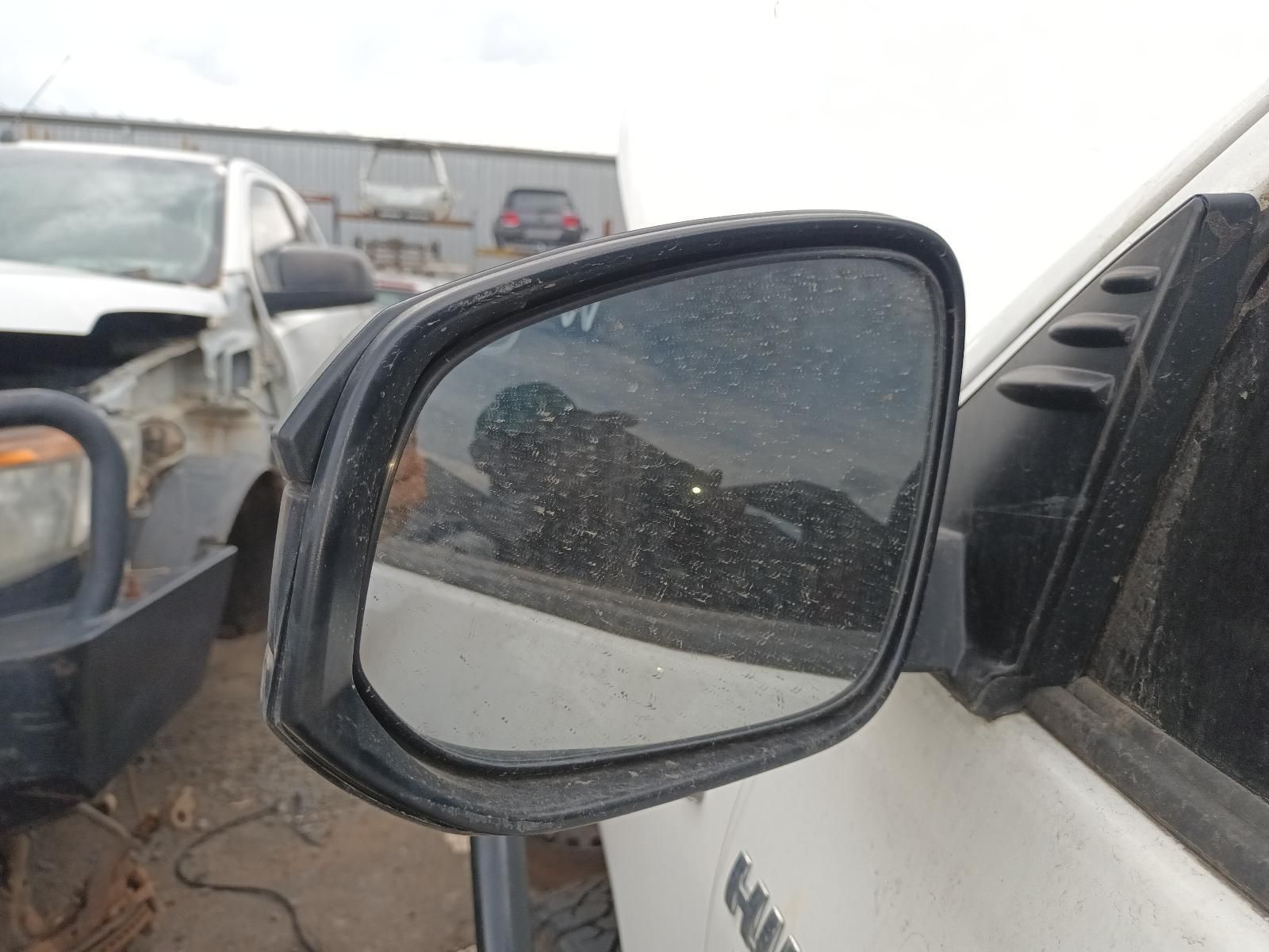 Close-Up of A White Car’s Side Mirror with A Dusty Parking Lot — South West 4WD Wreckers In Harristown, QLD