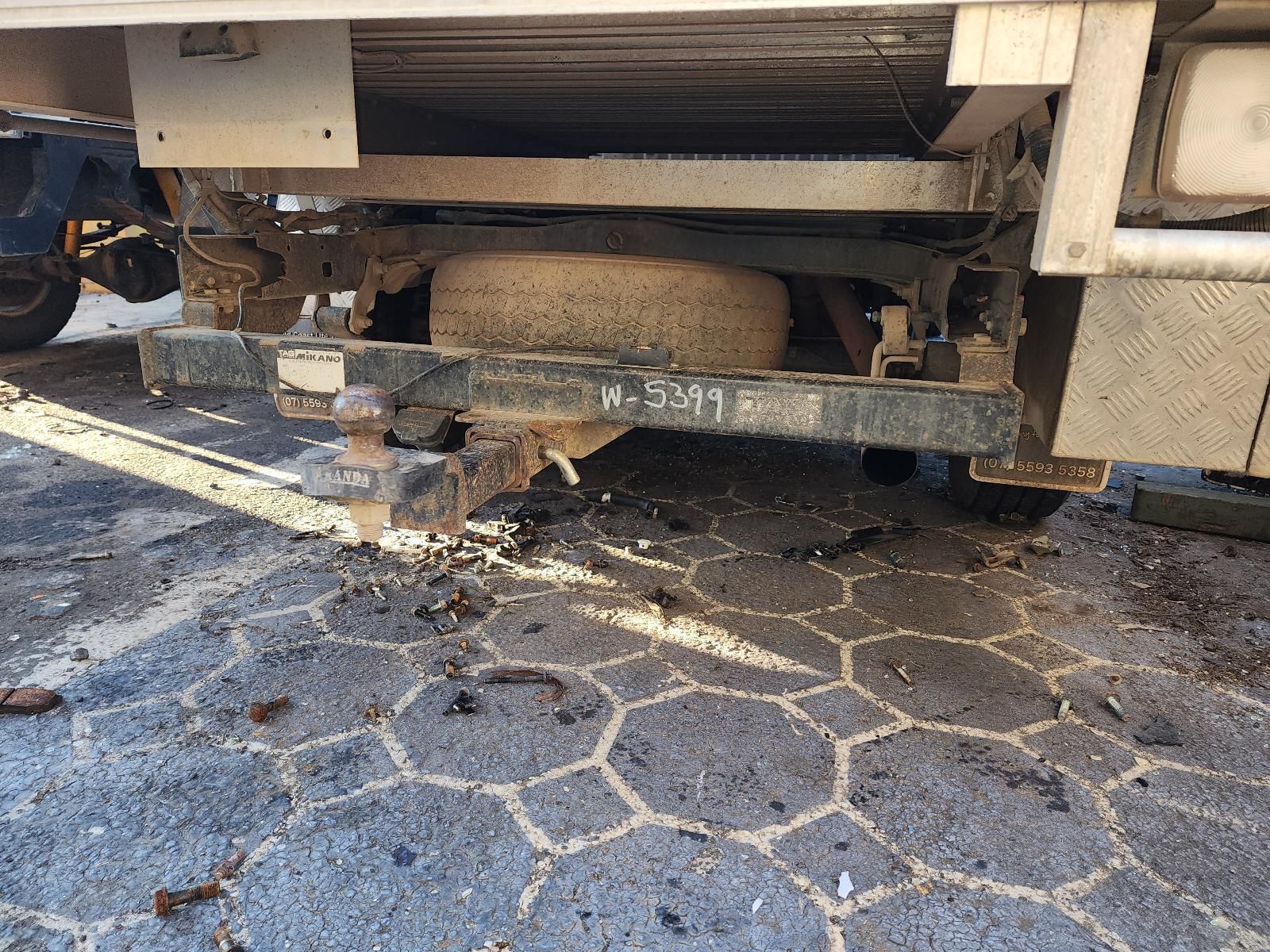 Rusty Underside of a Vehicle Parked Over Cracked Pavement — South West 4WD Wreckers In Harristown, QLD