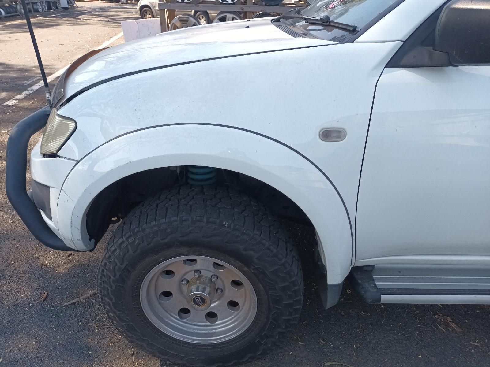 White Suv with A Blue Front Bumper and Off-Road Tyres Parked on A Dirt Road — South West 4WD Wreckers In Harristown, QLD
