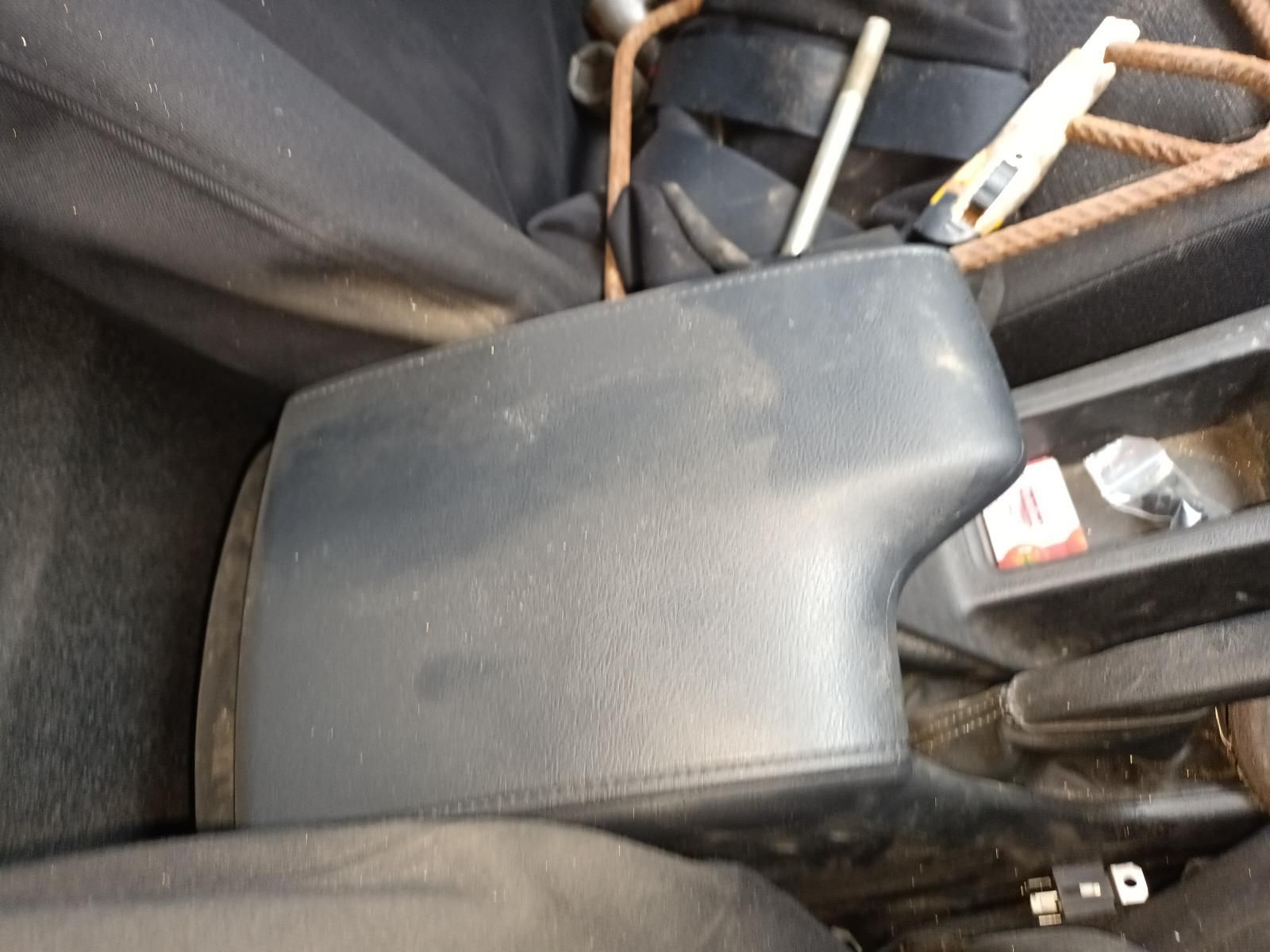 Grey Plastic Armrest Beside Folded Metal Bars and Tools in A Car Interior — South West 4WD Wreckers In Harristown, QLD