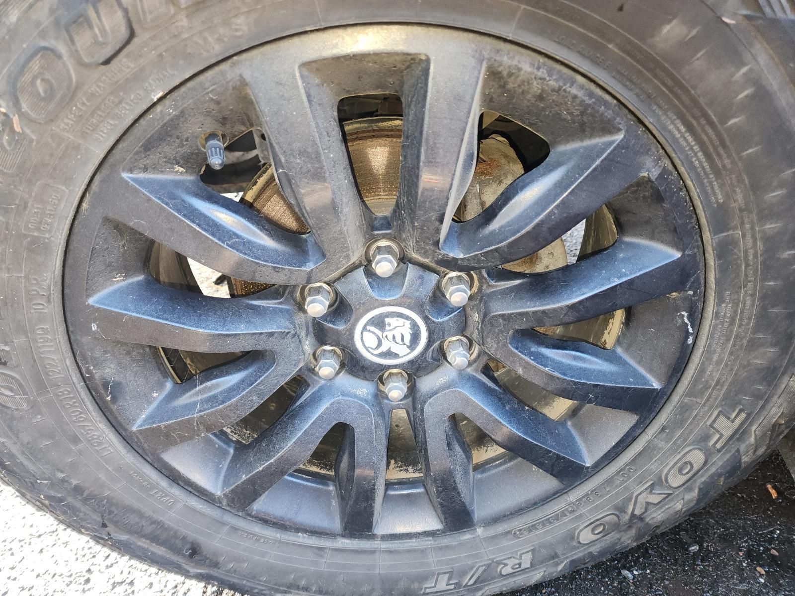 Black Alloy Car Wheel With Tire, Showing Dirt — South West 4WD Wreckers In Harristown, QLD