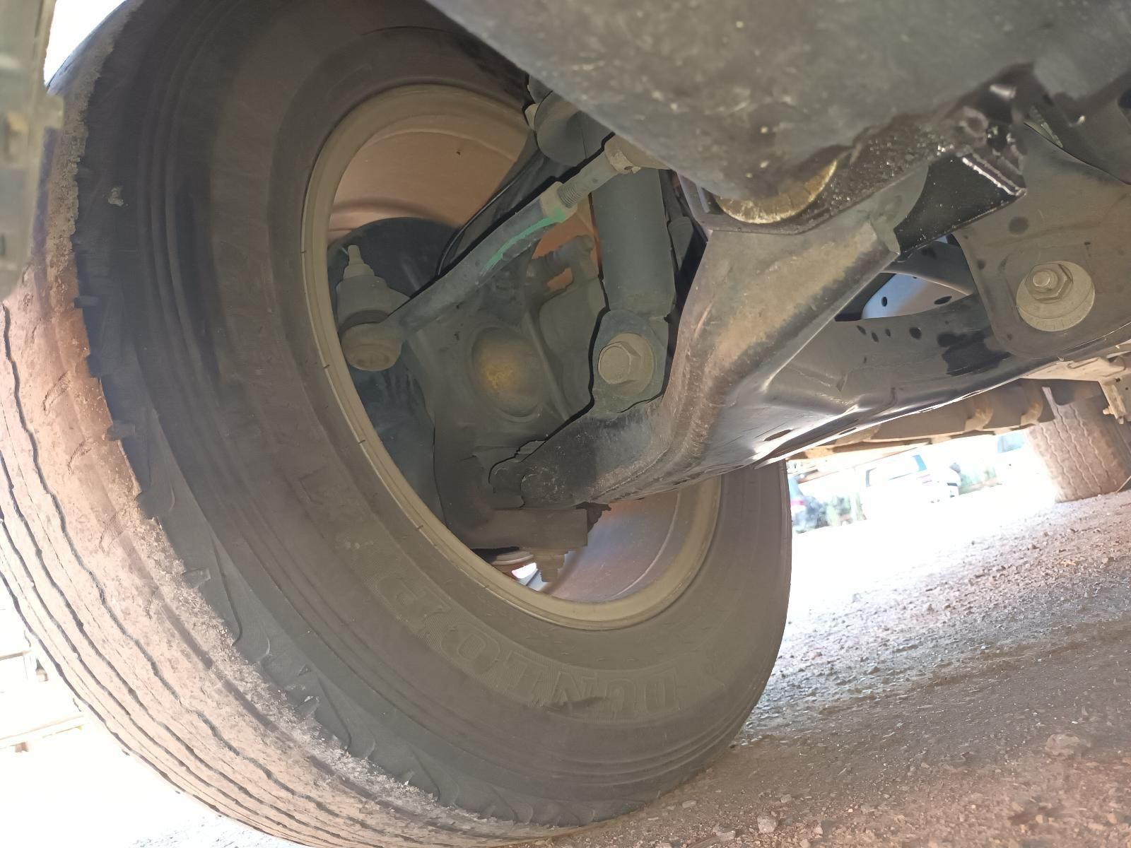Close-Up of A Car’s Rear Wheel and Suspension Undercarriage on A Dirt Surface — South West 4WD Wreckers In Harristown, QLD