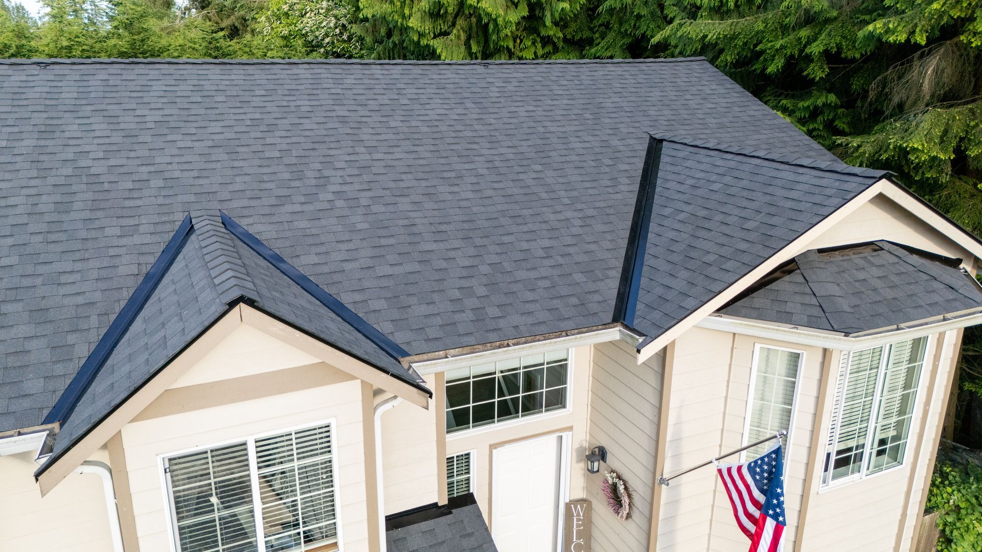 Newly shingled roof on a home with a covered entryway