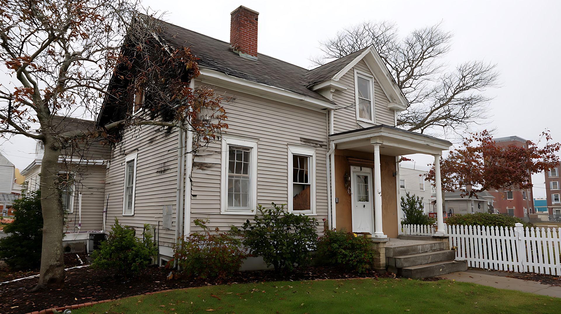 Older residential home with visibly worn and deteriorating siding showing signs of needed siding rep