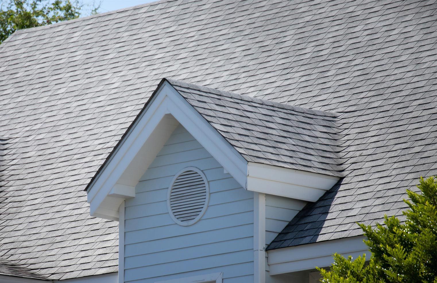 A house with a gray roof and a white trim