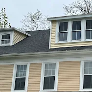 A house with a gray roof and a lot of windows.