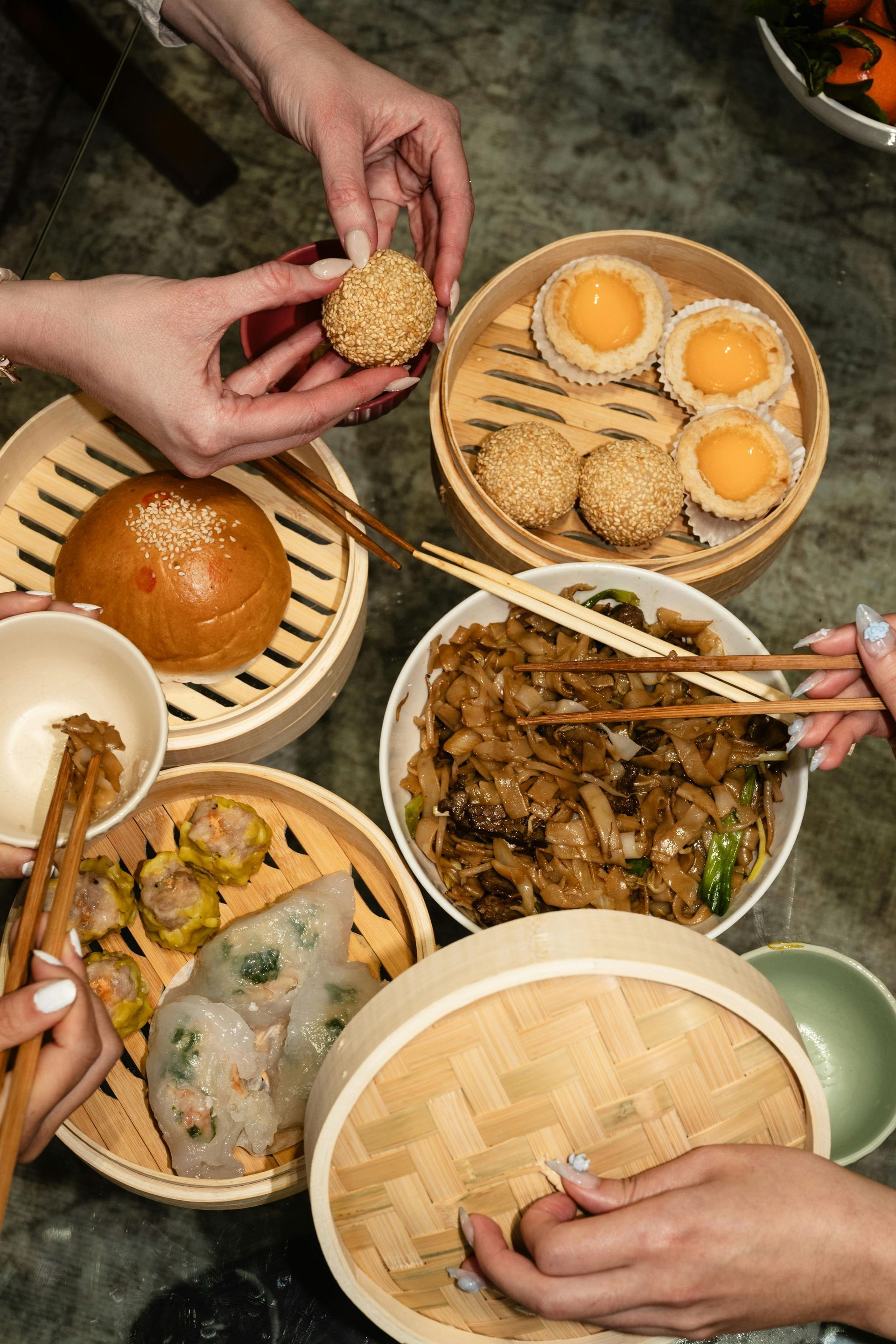 Food on plates with people's hands 