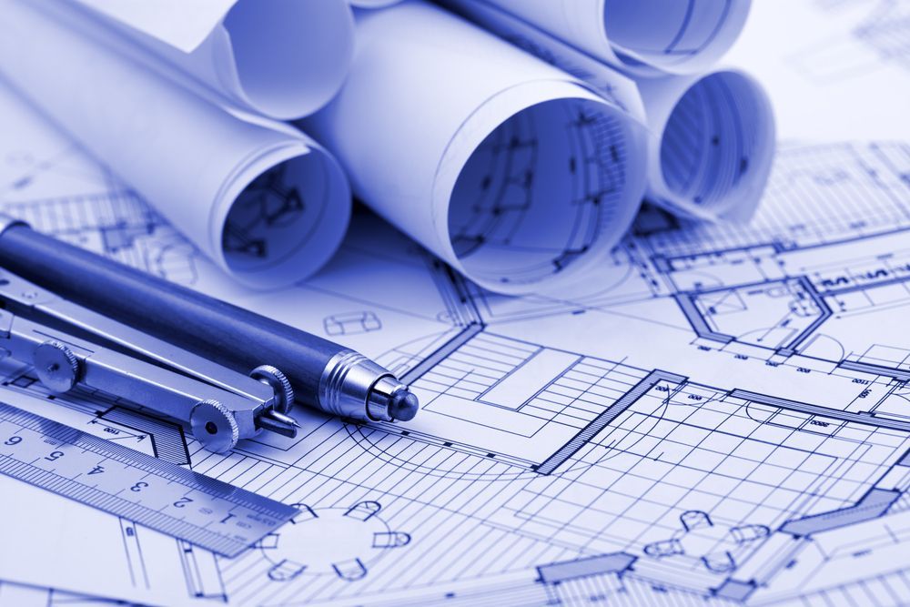 Blue-toned Architectural Blueprints With Rolled-up Drawings — GS Design & Drafting In Lismore, NSW