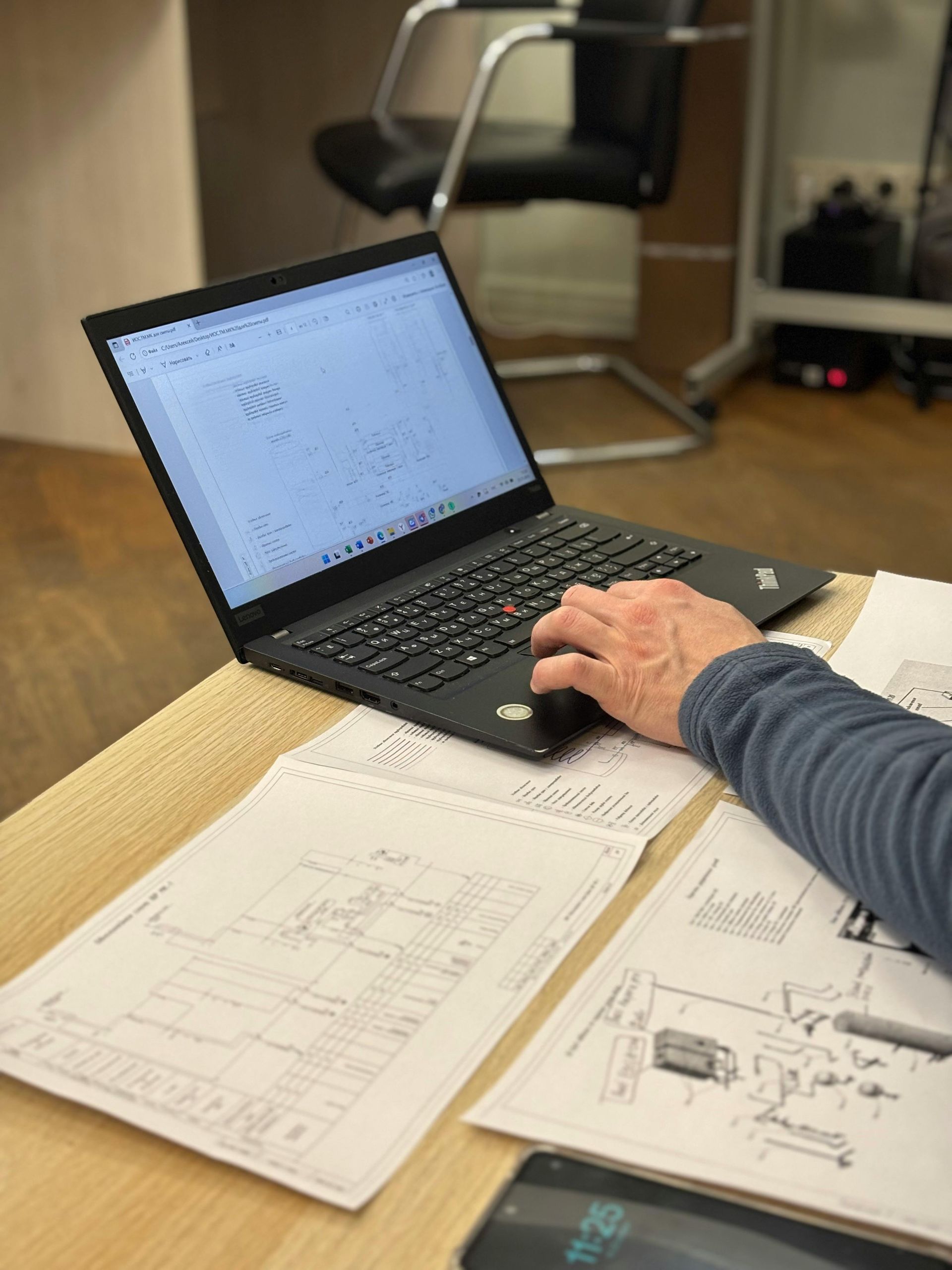 Person Working On A Laptop, Reviewing Papers — GS Design & Drafting In Rous, NSW