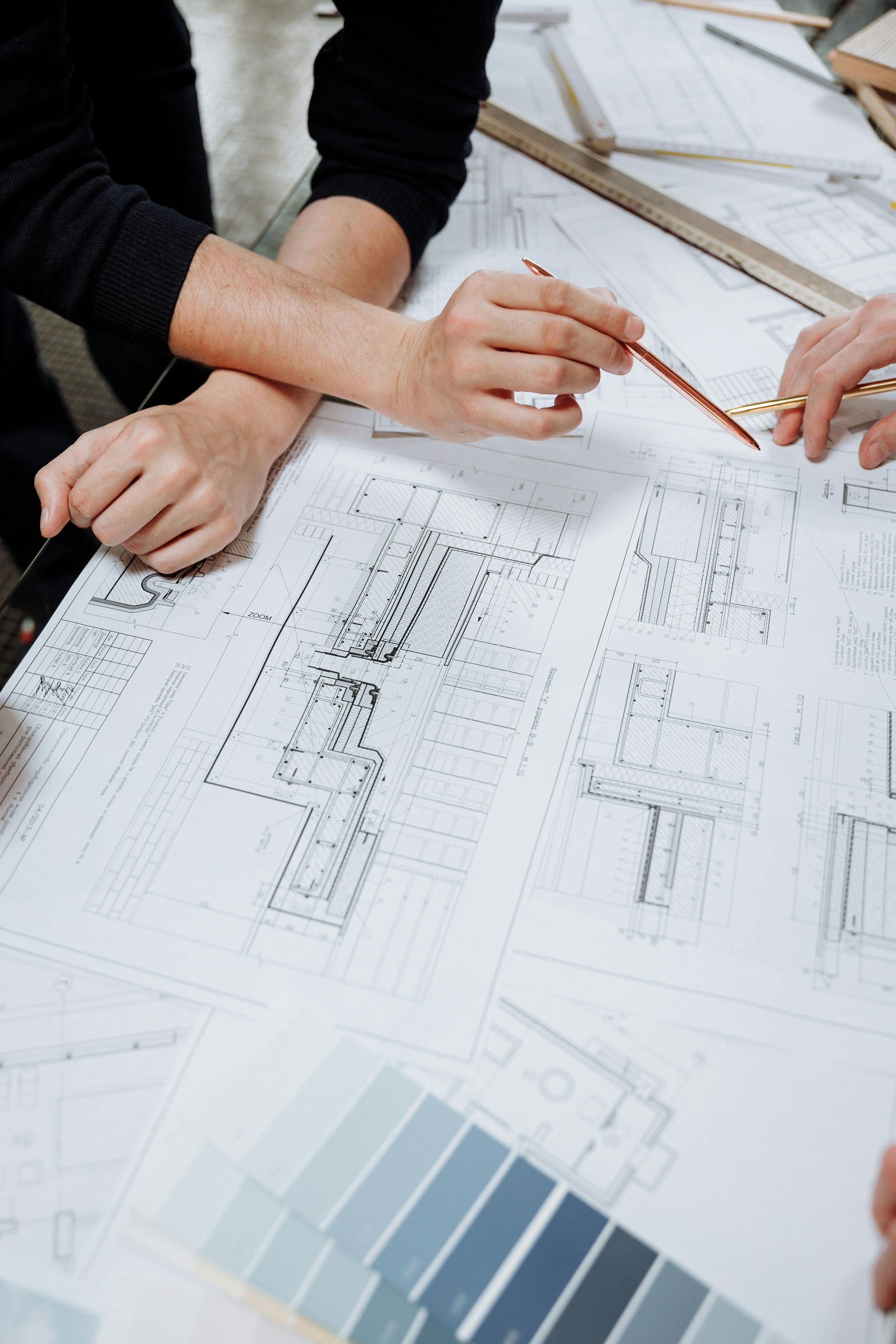 Hands Pointing At Architectural Blueprints — GS Design & Drafting In Lismore, NSW
