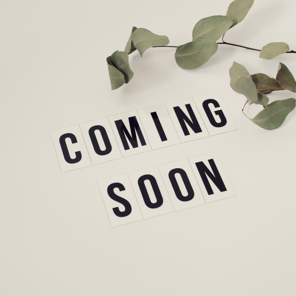 “COMING SOON” text on a light background with green leaves overhead
