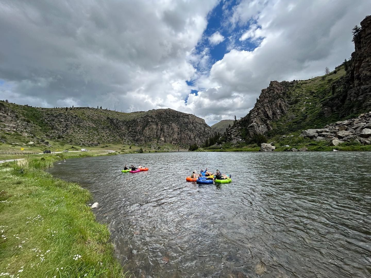 A group of people are floating down a river in rafts.