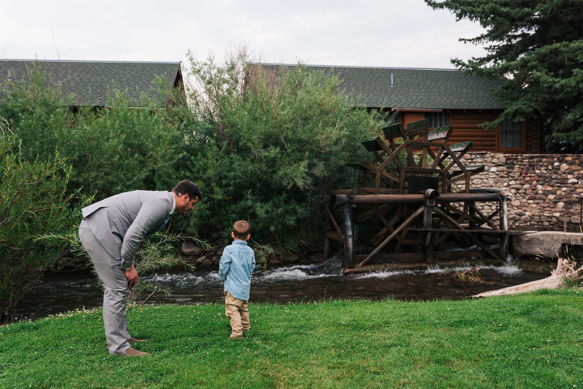 Father and son investigate waterwheel at El Western