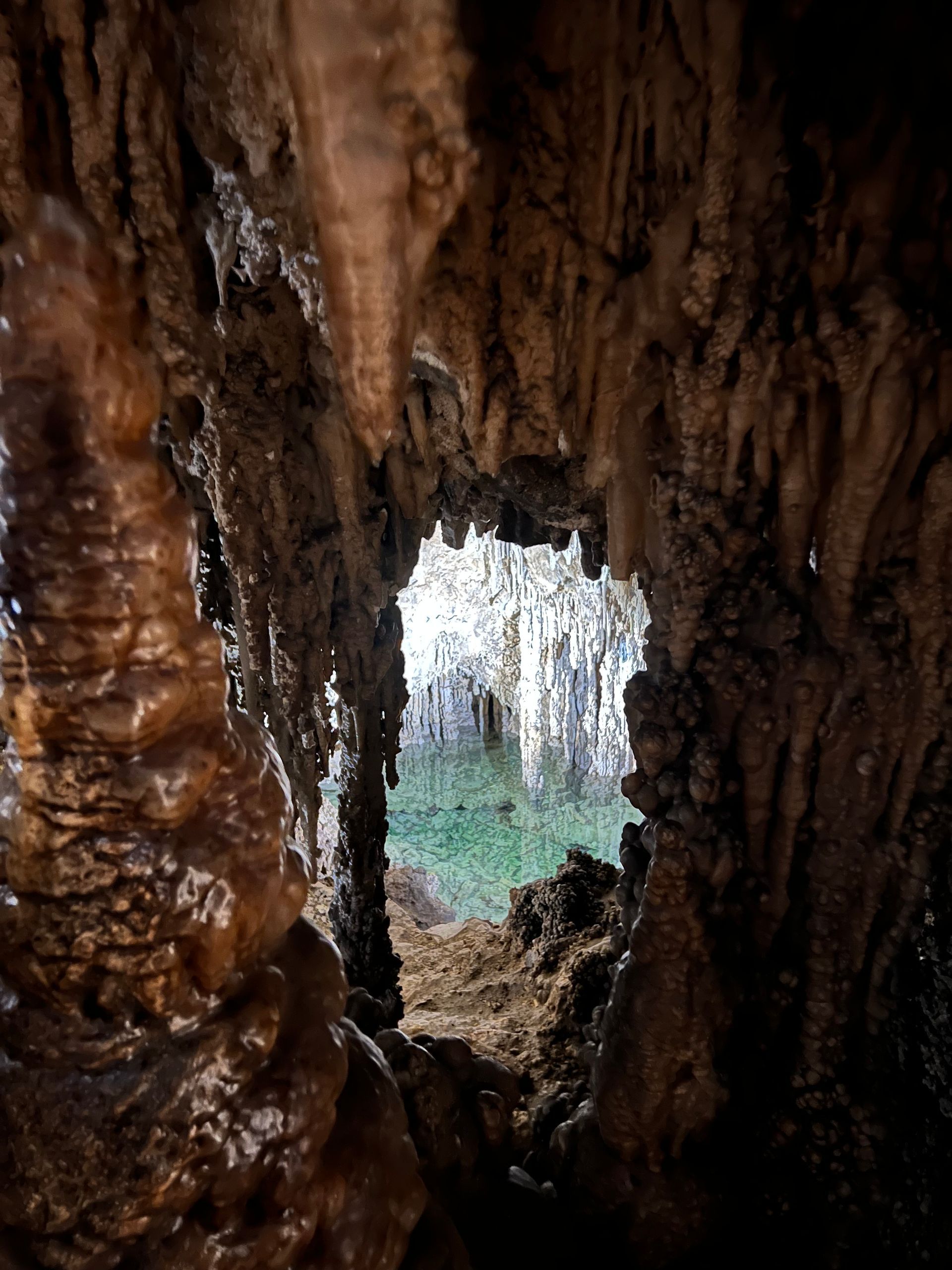 A view of a cave through a hole in the wall.