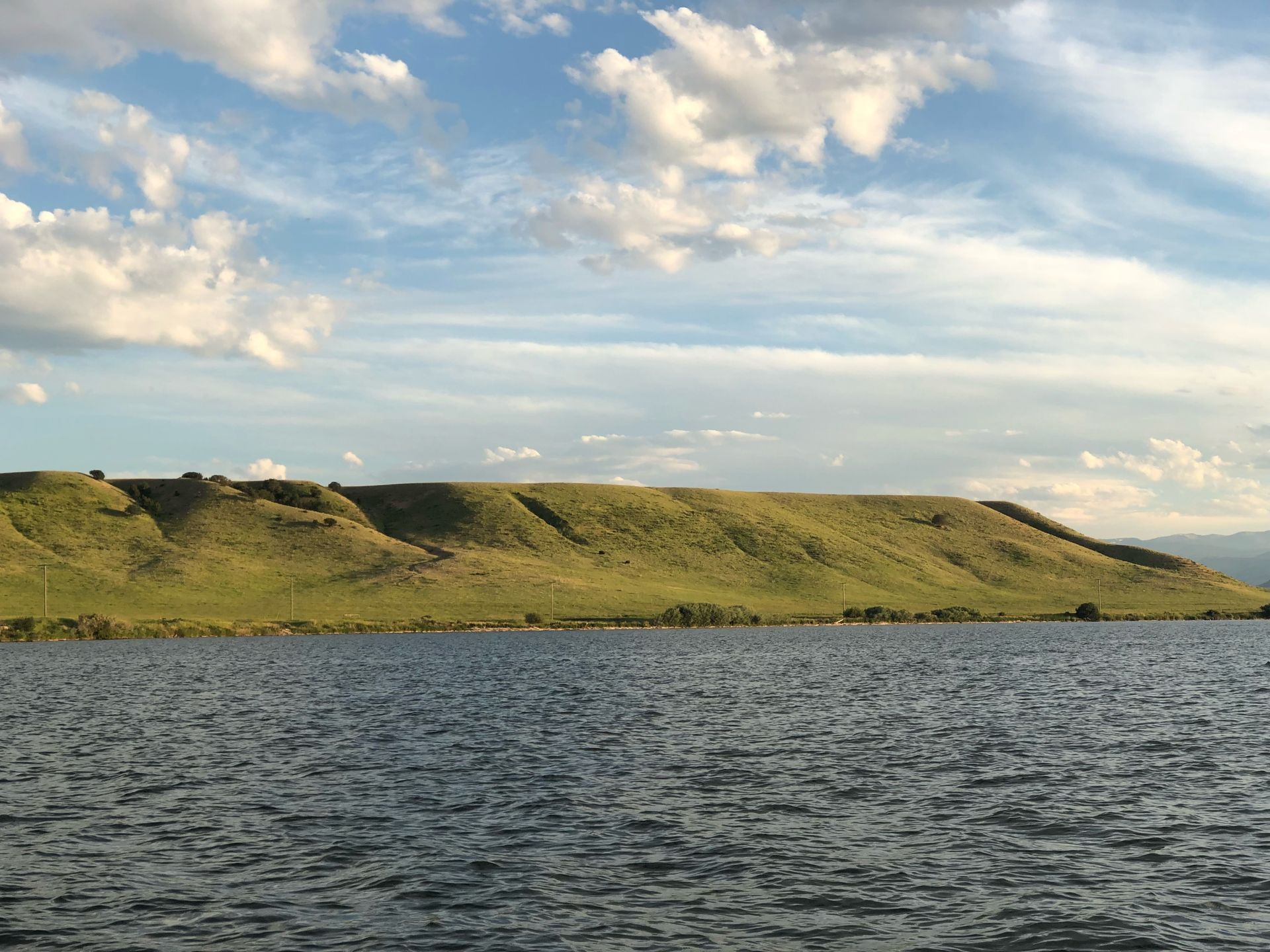 A large body of water with a mountain in the background.