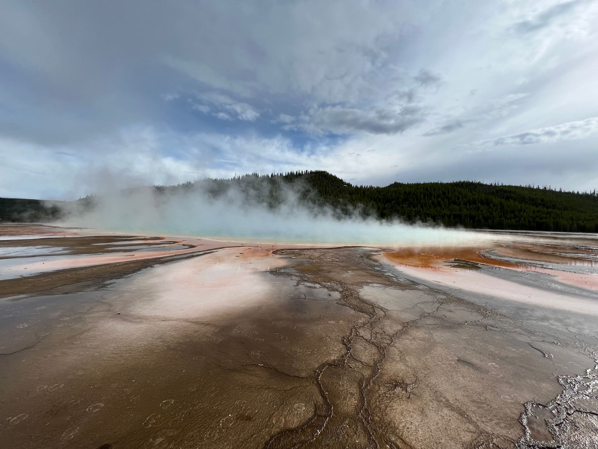 A large body of water with steam coming out of it.