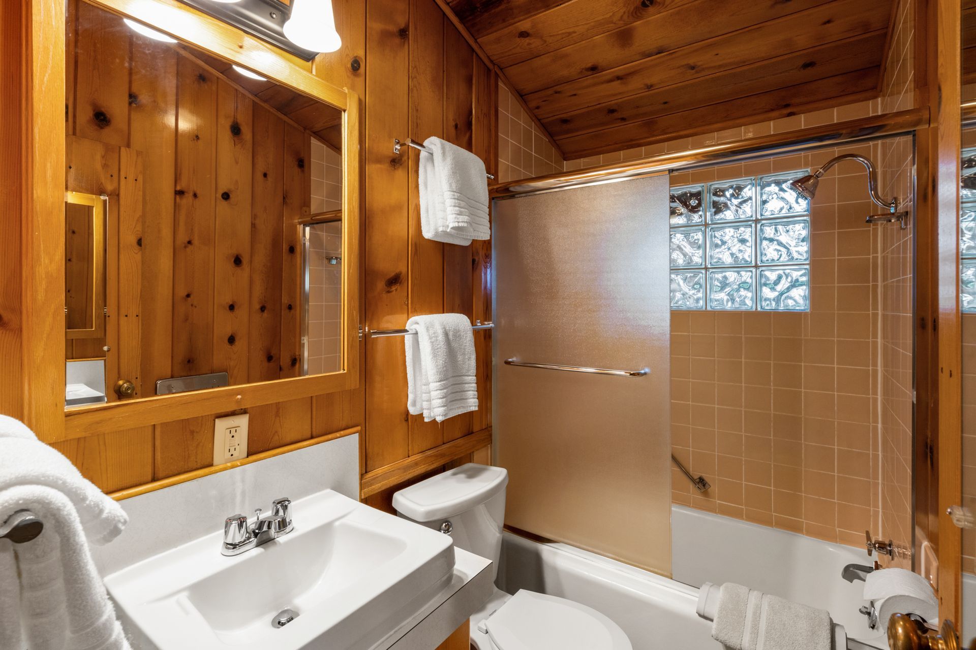 A bathroom with a sink , toilet , bathtub and mirror.