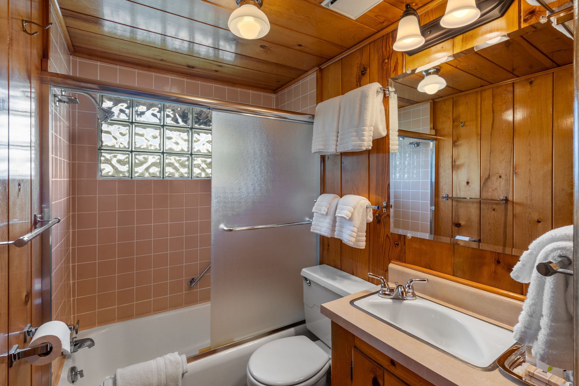 A bathroom with a sink , toilet , bathtub and mirror.