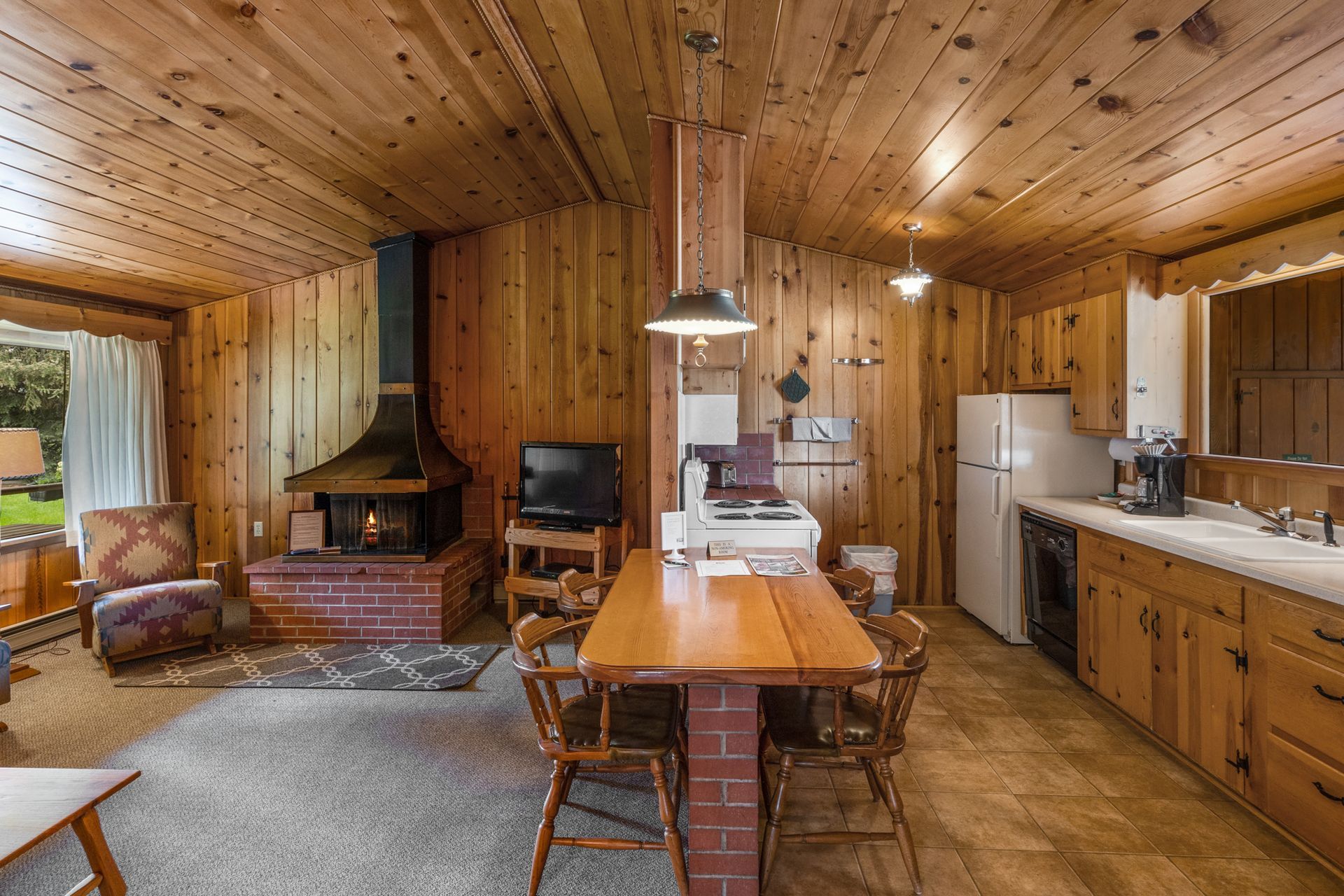 There is a table and chairs in the middle of the room.