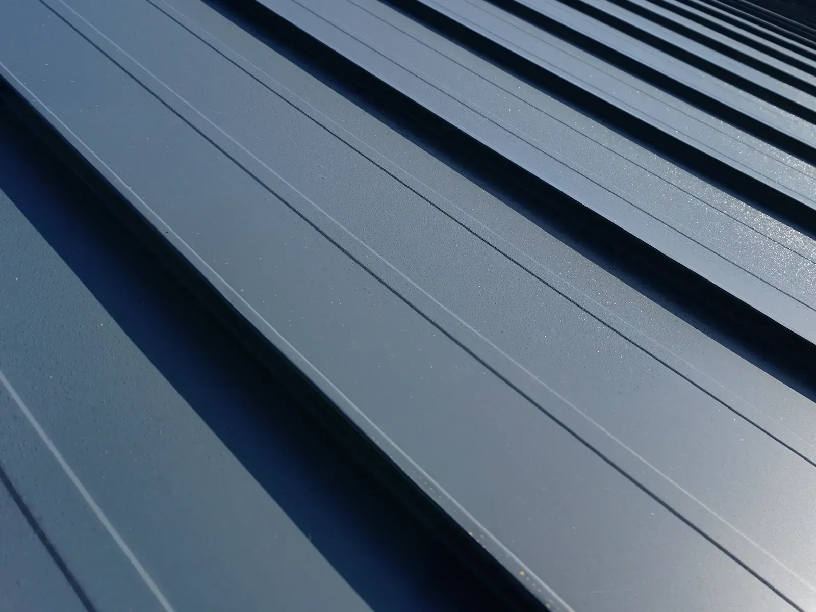 Standing seam metal roofing installation in Beaverton, Oregon featuring concealed fasteners and superior water protection.