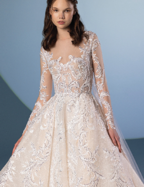 A woman is wearing a wedding dress with long sleeves.