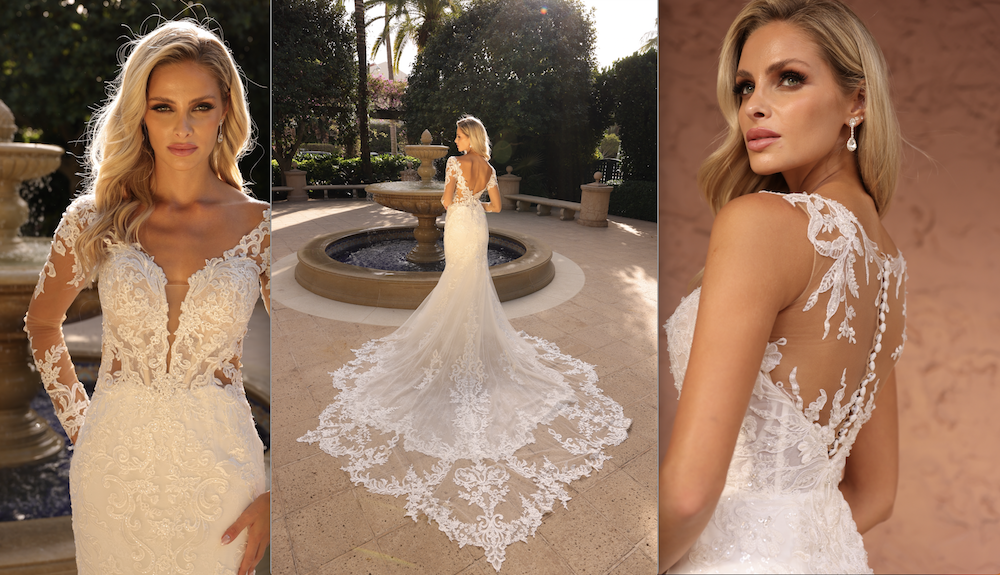 Woman in a white lace wedding dress with a long train, posed outdoors by a fountain.