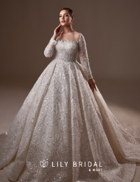 A woman is wearing a white wedding dress from lily bridal