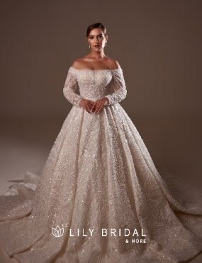 A woman is wearing a wedding dress from lily bridal