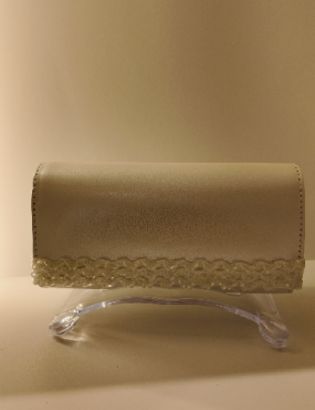 Beige leather clutch purse on a clear acrylic stand against a beige background