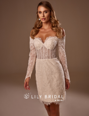 A woman is wearing a white lace dress with long sleeves.