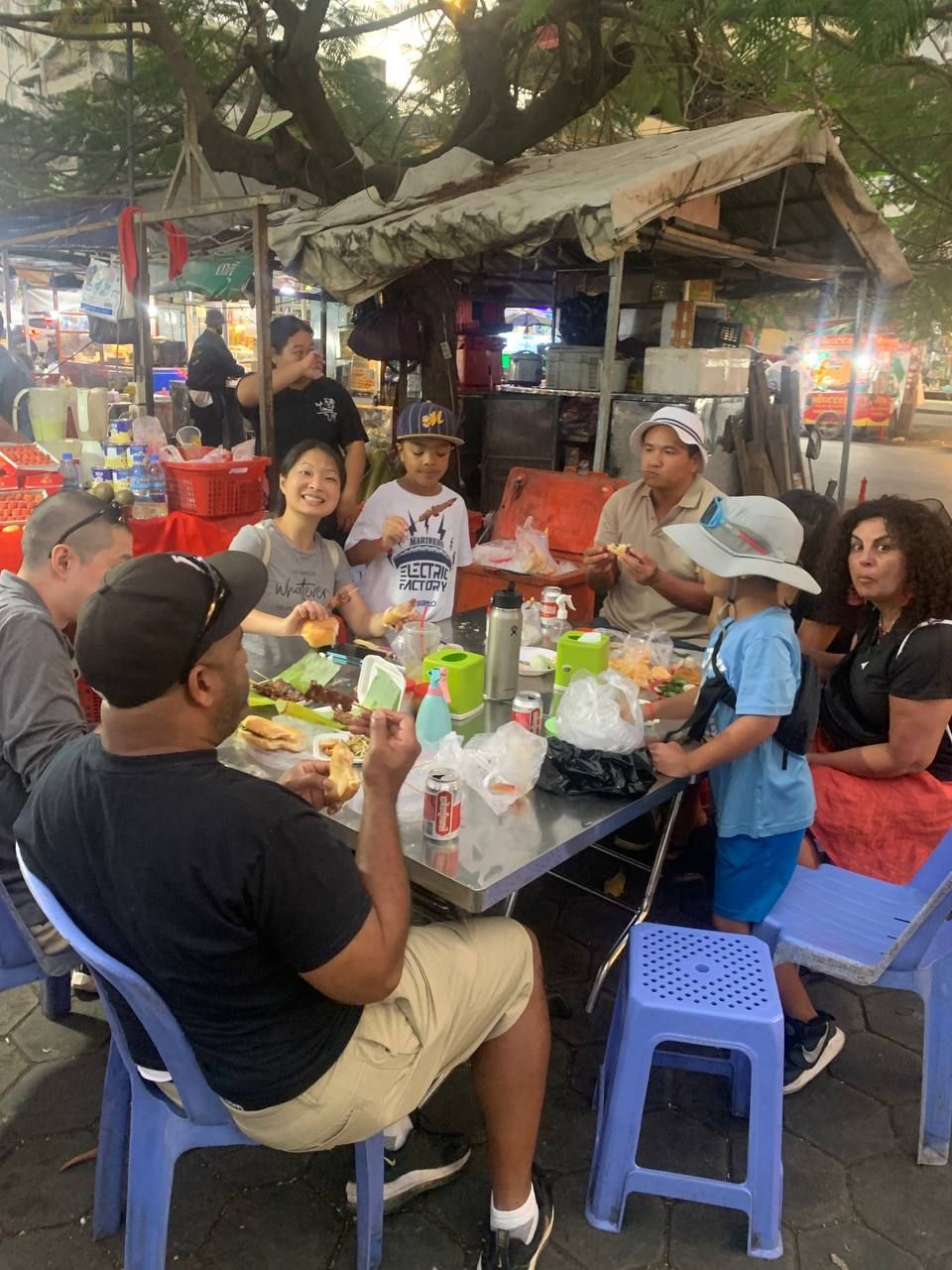 Private Siem Reap street food tour by tuk-tuk with local guide serving traditional Khmer dishes at night market stalls.