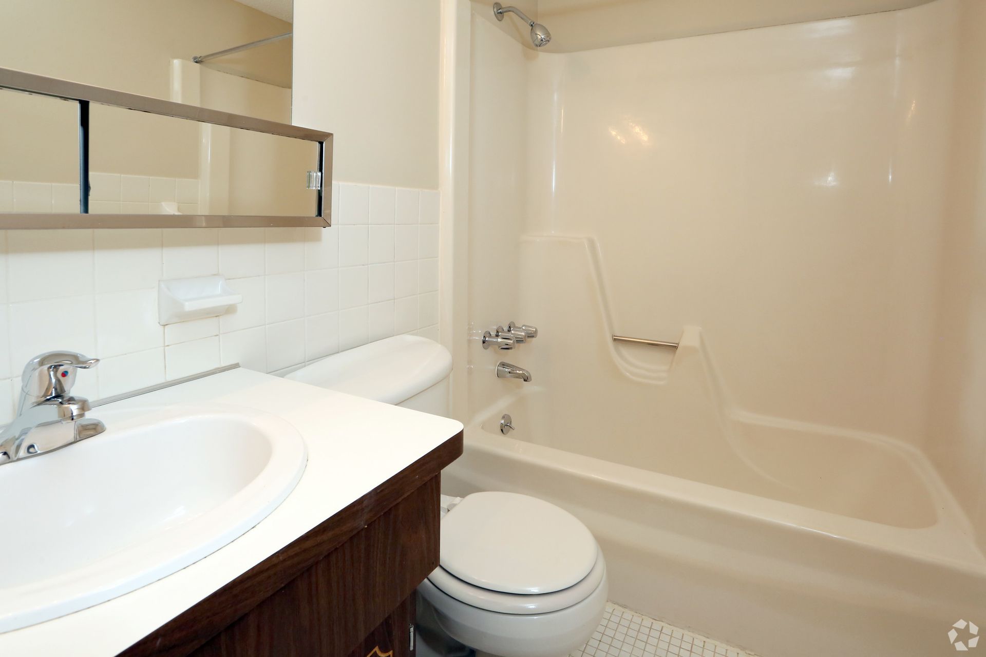 A bathroom with a toilet , sink and bathtub