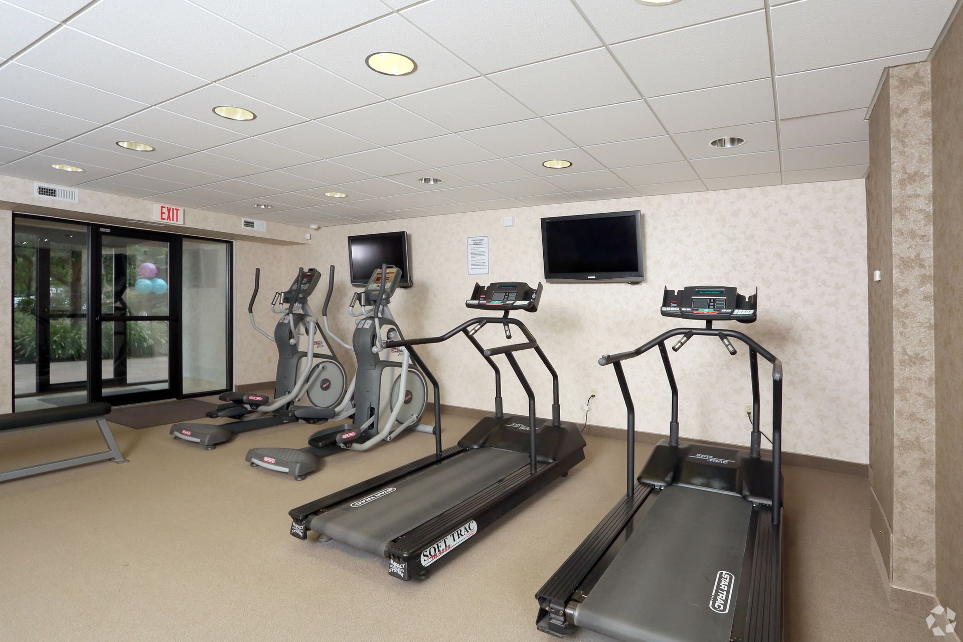 A gym filled with treadmills and exercise bikes