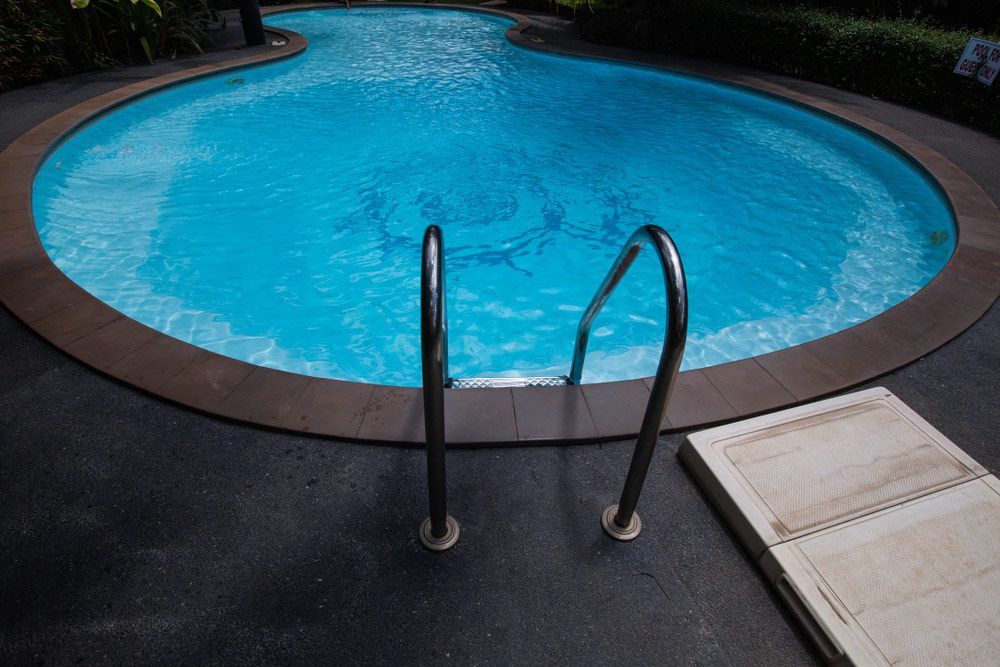 Round Pool Shaped Pool Surrounded By Trees, Swimming Pool And Water Filter — Professional Pool Builder in Temora, NSW