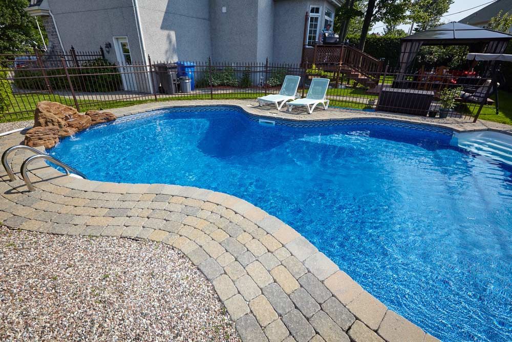View Swimming Pool And Two Chairs — Professional Pool Builder in Temora, NSW