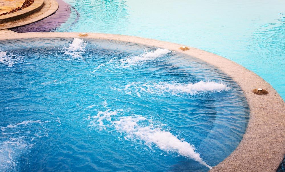 Outdoor Jacuzzi Pool With Fresh Blue Water For Massage And Spa — Professional Pool Builder in Temora, NSW